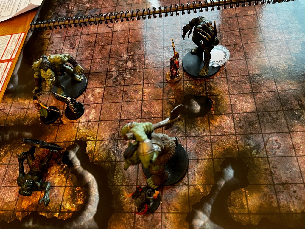 A group of trolls fighting the adventurers in a cave