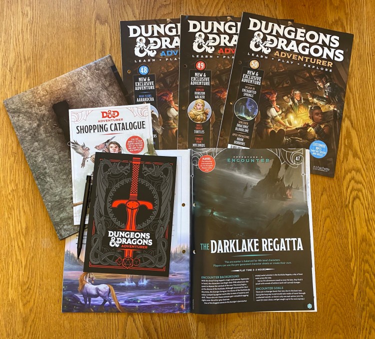 D&D Adventurer magazines, battle map, notebook, magazine open at The Darklake Regatta