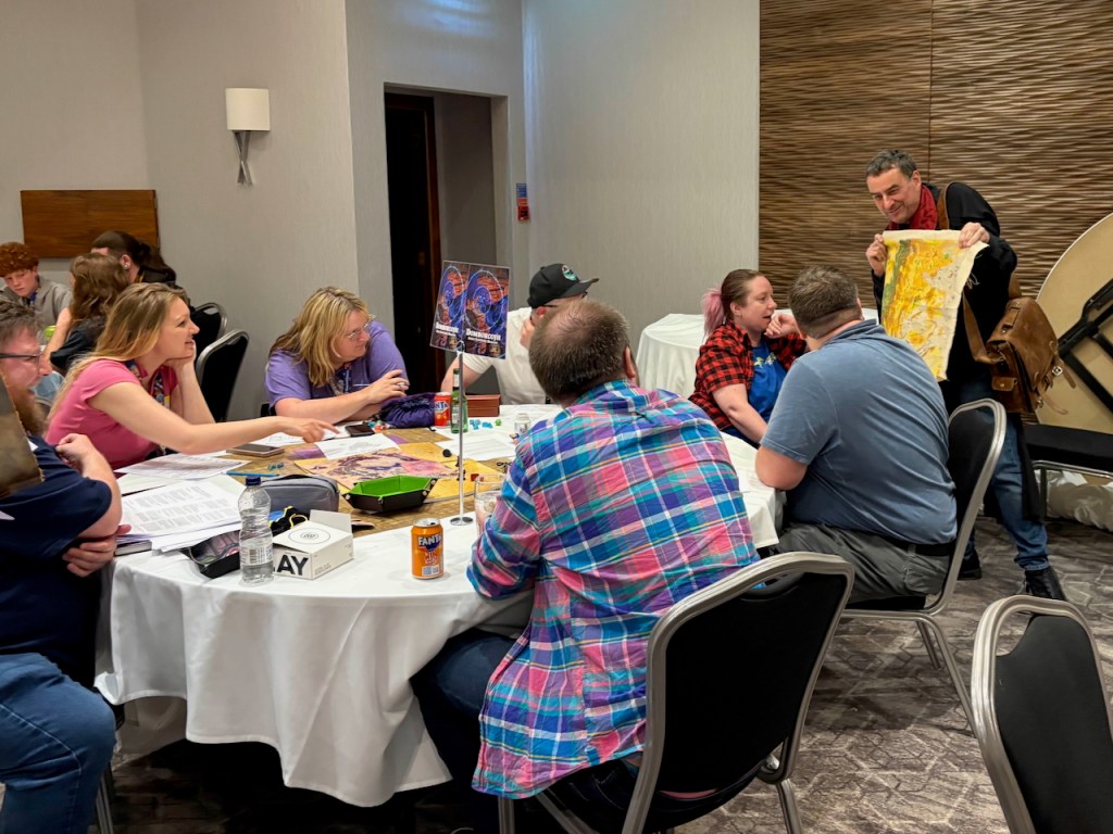 Richard showing a cloth map to a table of D&D players
