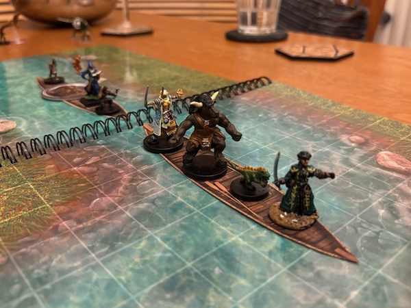 PC minis in canoe on river battle map