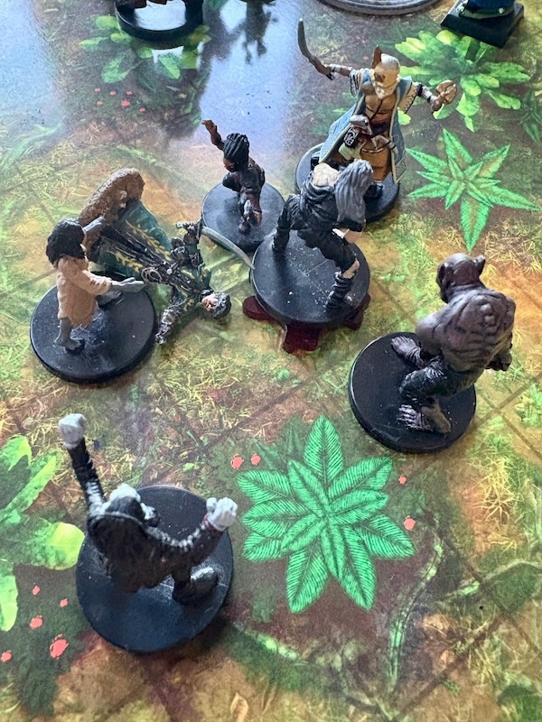 PC and zombie minis on jungle battle map