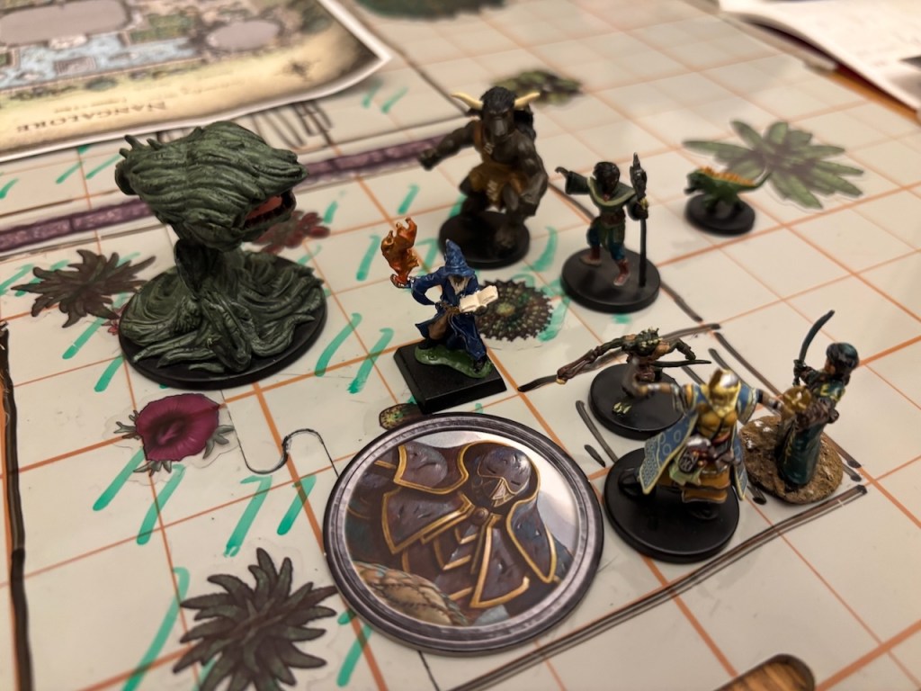 PC minis battling large carnivorous plant min on hand drawn battle mat.