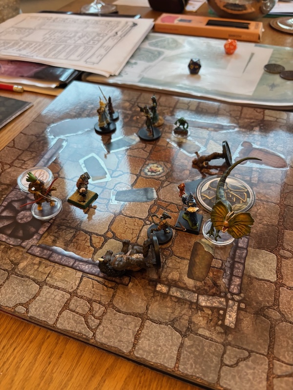 PC minis fighting tabaxi hunter on battle map depicting ruined basement
