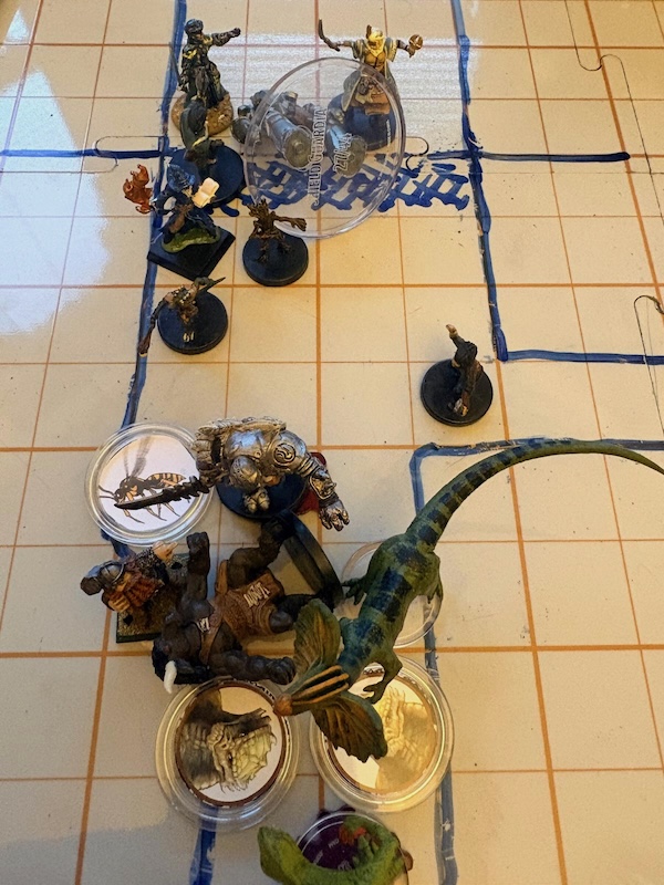 PC & monster minis and tokens on hand drawn battle map.