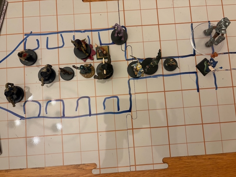 PC & monster minis battling on hand drawn battle map.