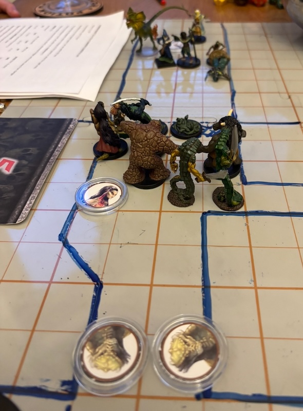 PC and monster minis on sketched battle map